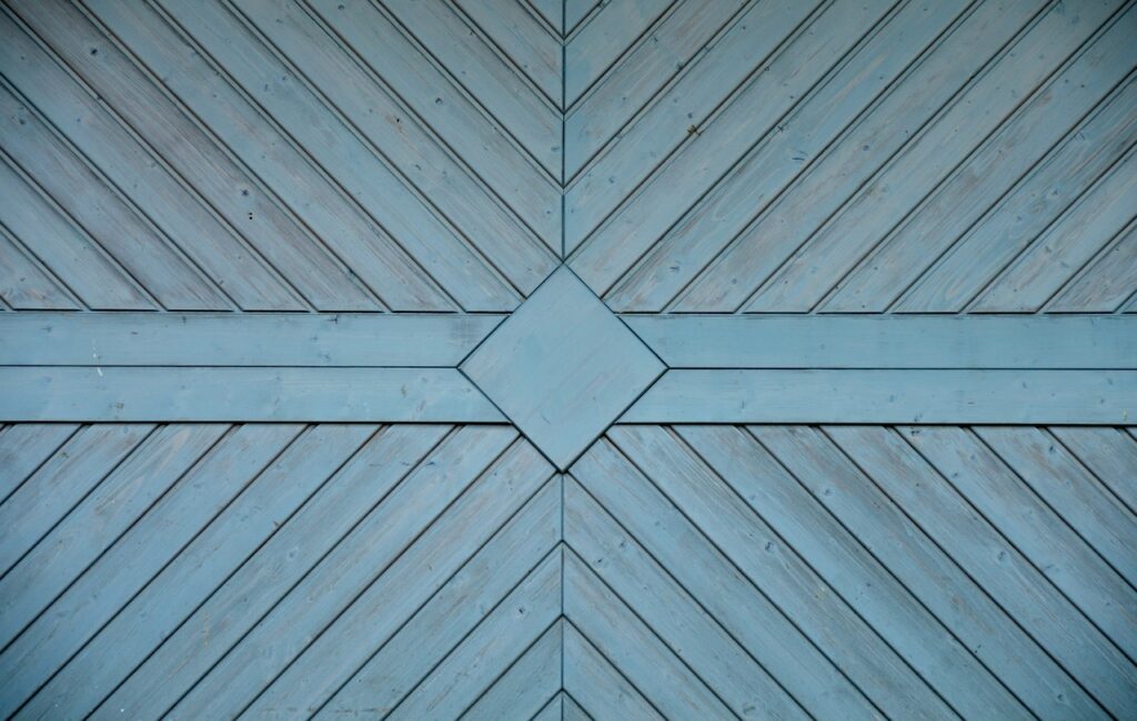 an image of a blue garage door needing help to Fix Garage Door