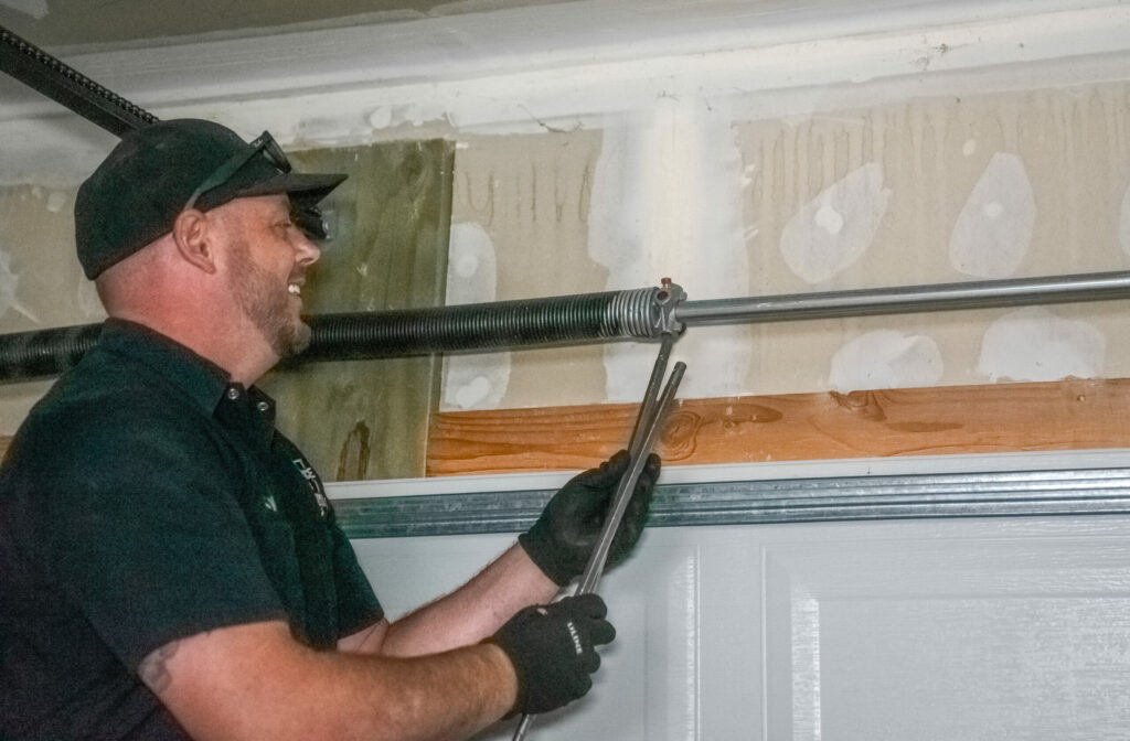 an image showing a gentleman fixing garage door springs