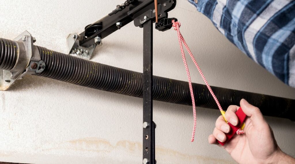 an image showing someone trying to fix a damaged garage door spring
